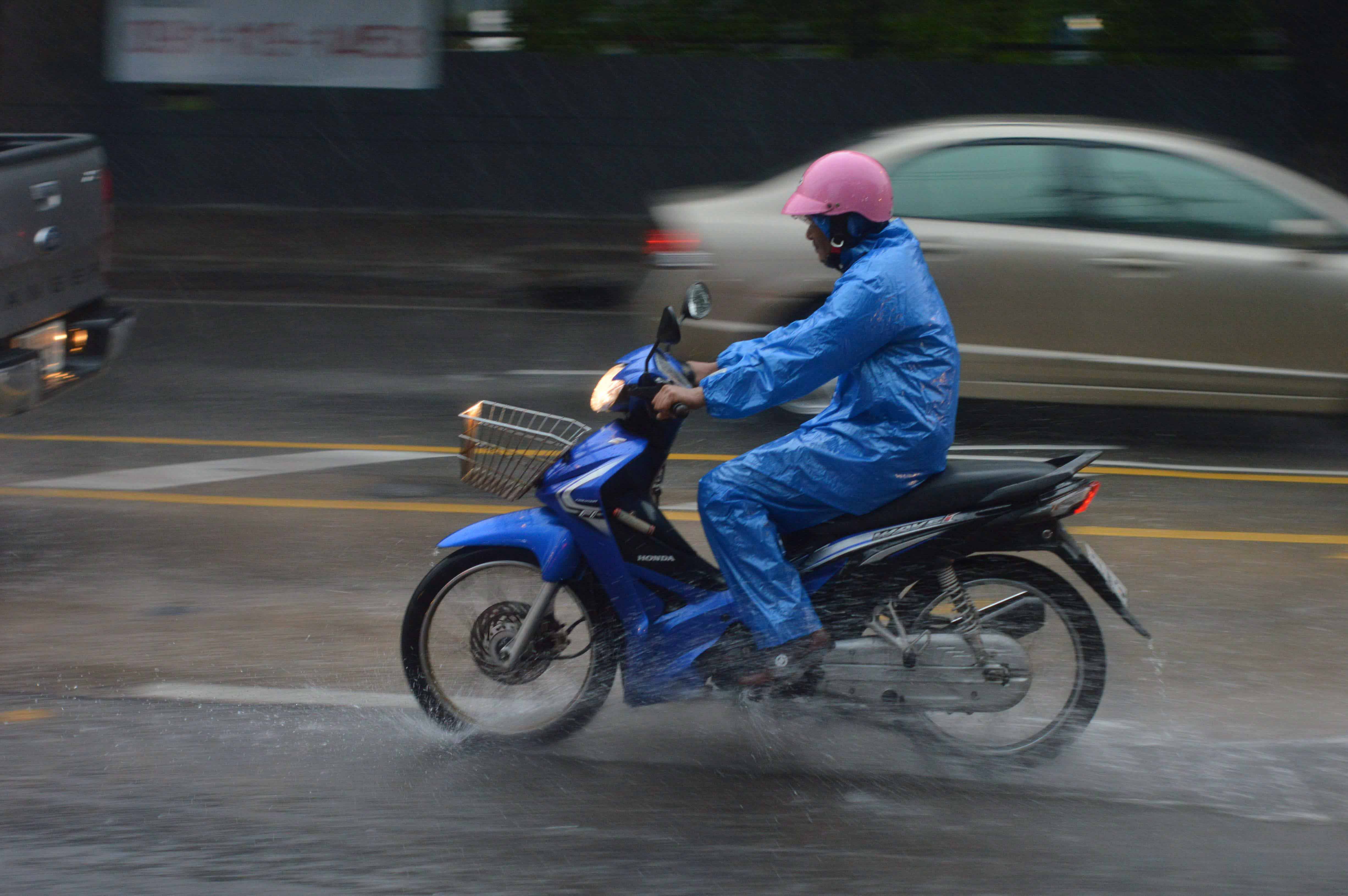 Thai motorcyclist panning, slow-shutter shot